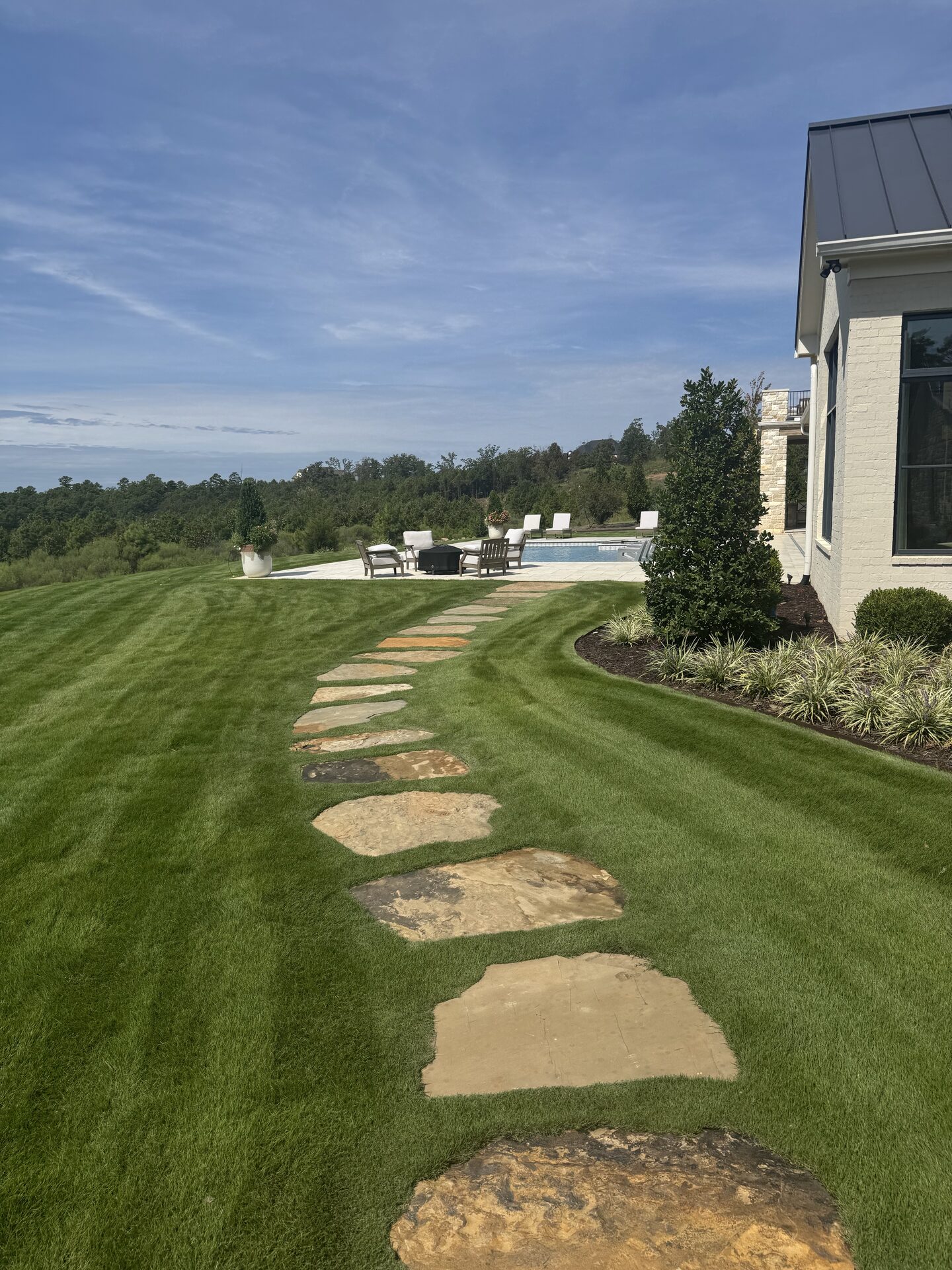 Approach view — pool house and landscaping