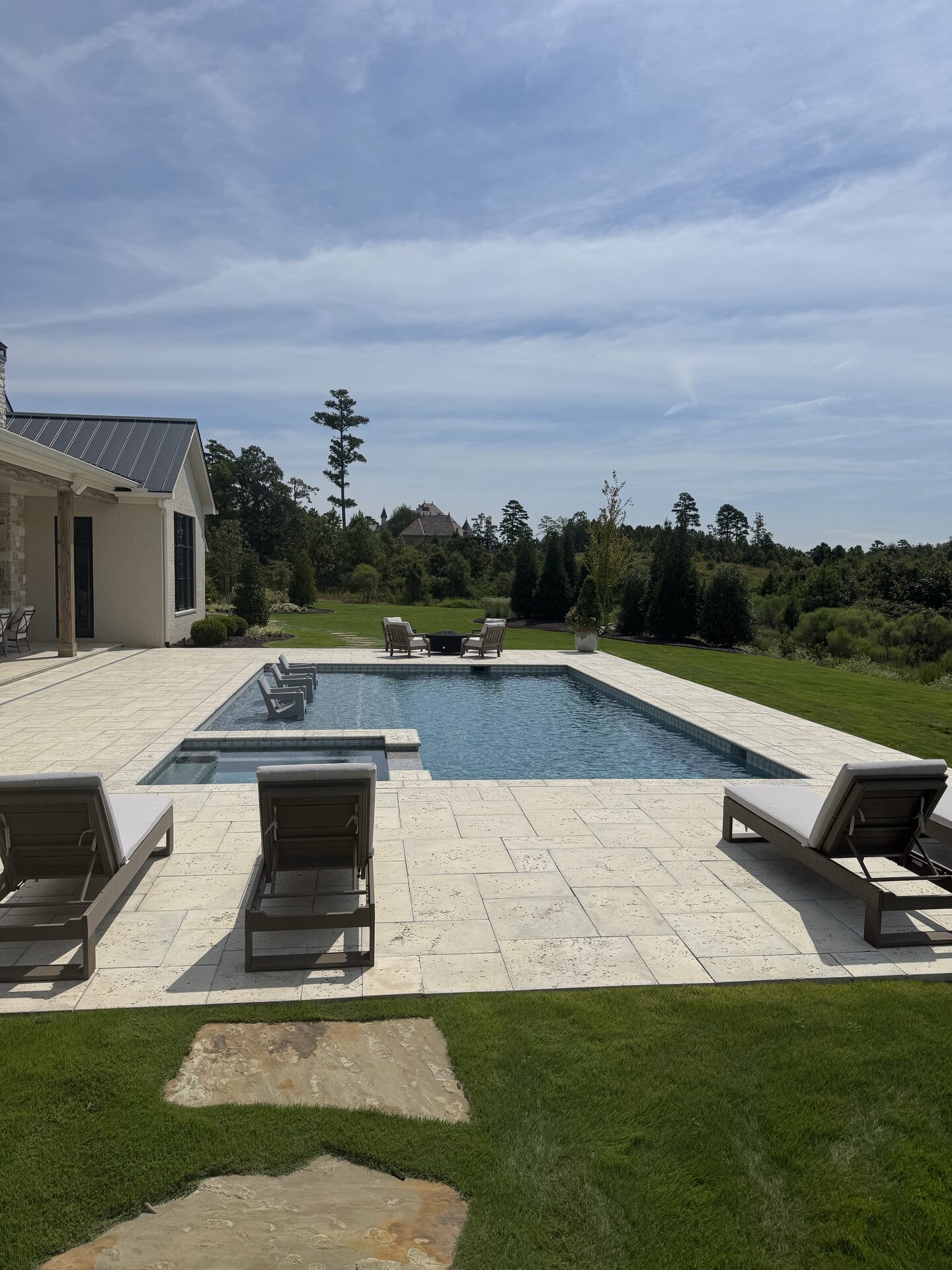 Pool deck with loungers and fire pit