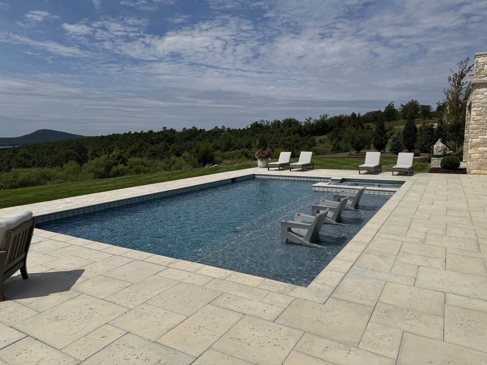 Pool with integrated spa and travertine coping