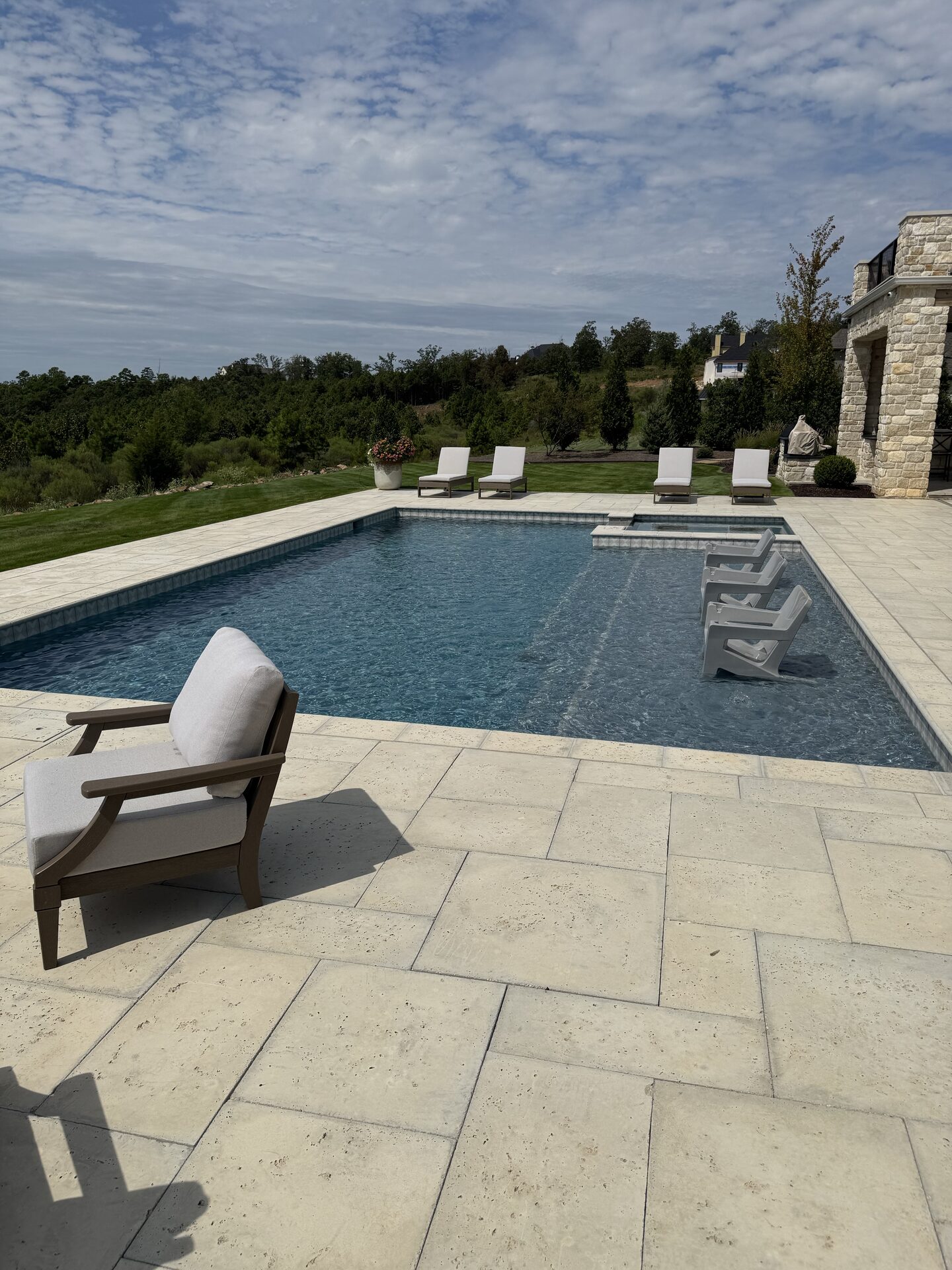 Poolside seating area with landscape views