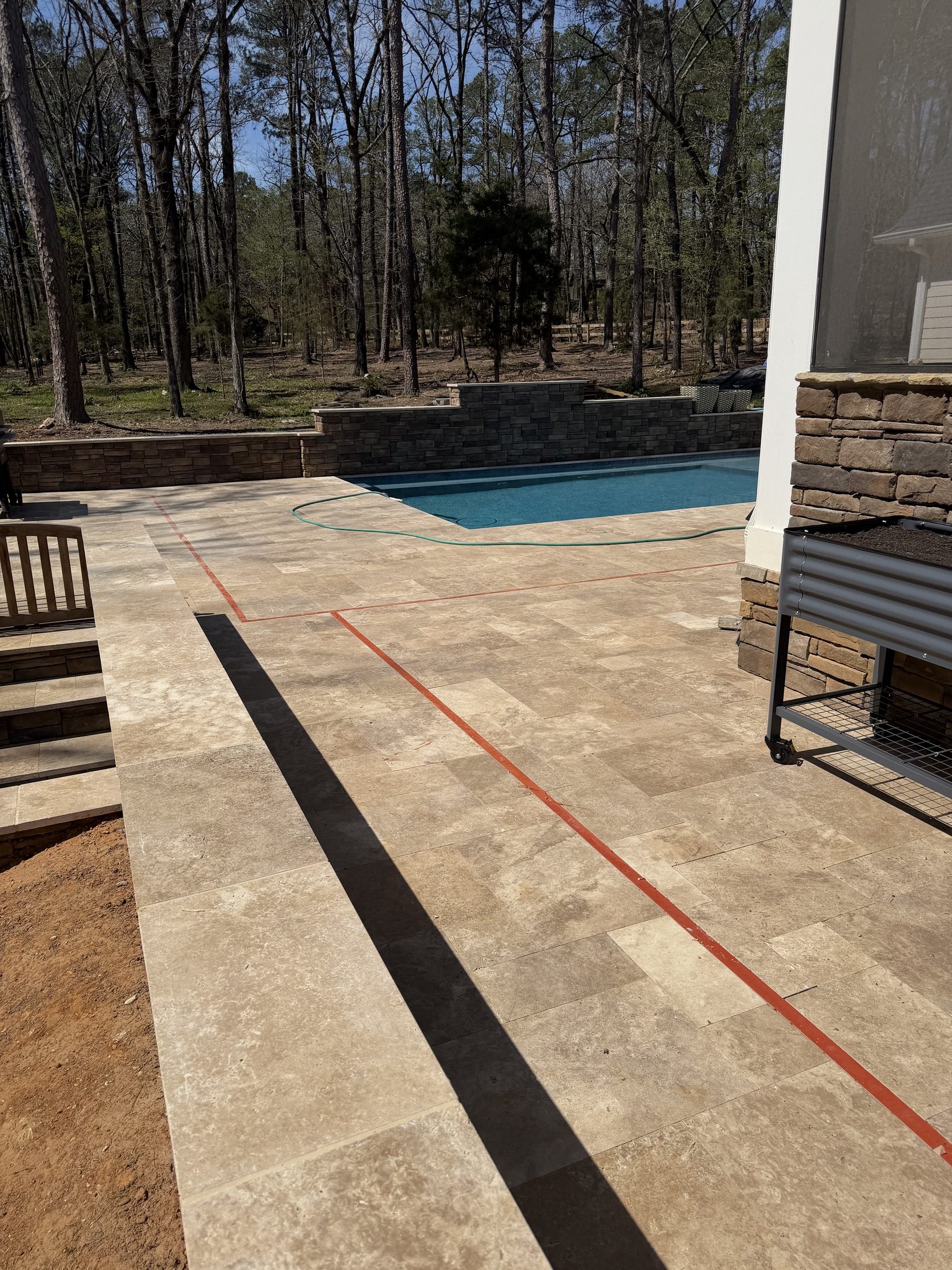 Pool and walnut travertine deck from above