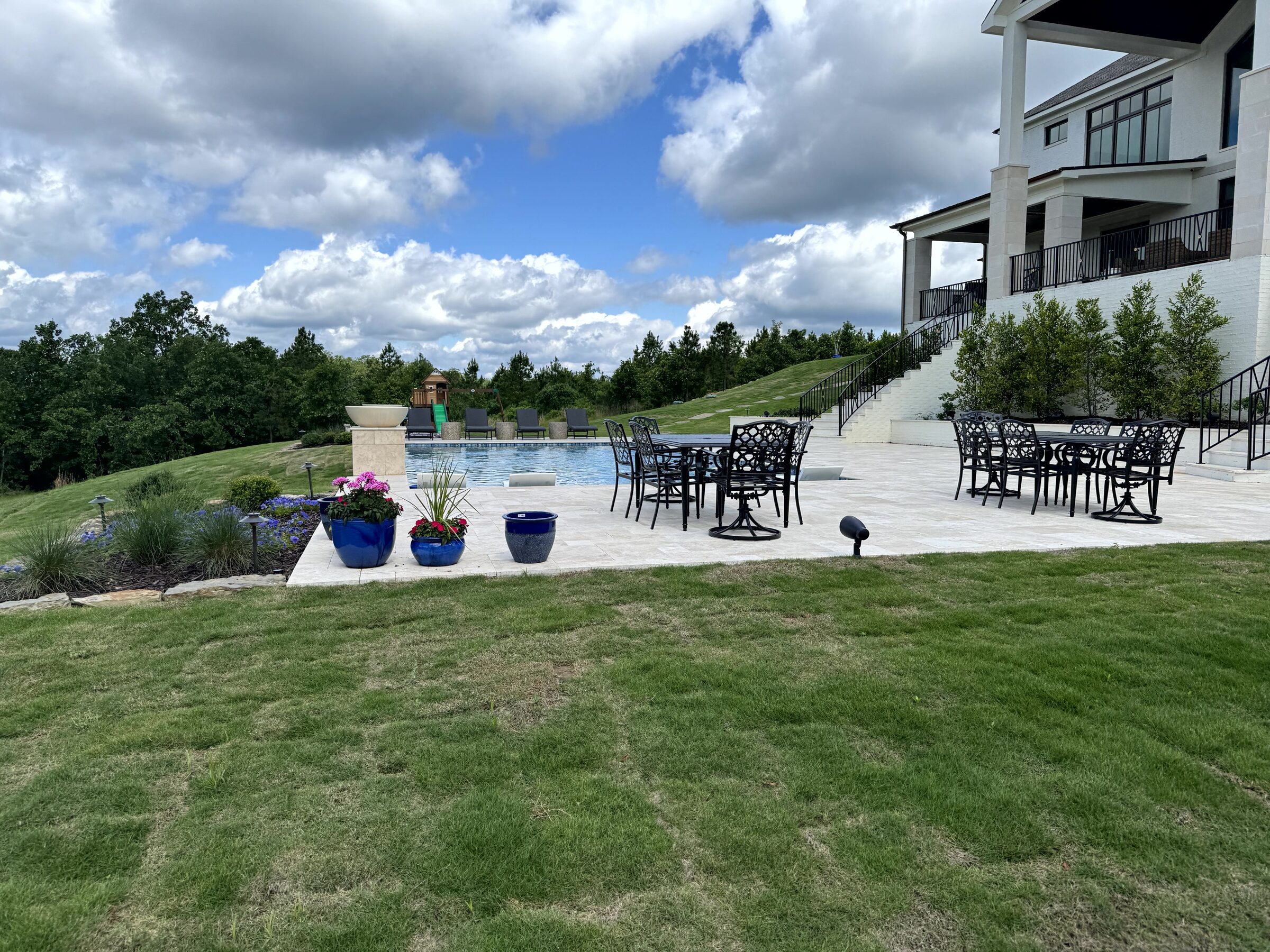 Upstairs patio detail — travertine caps and mountain views