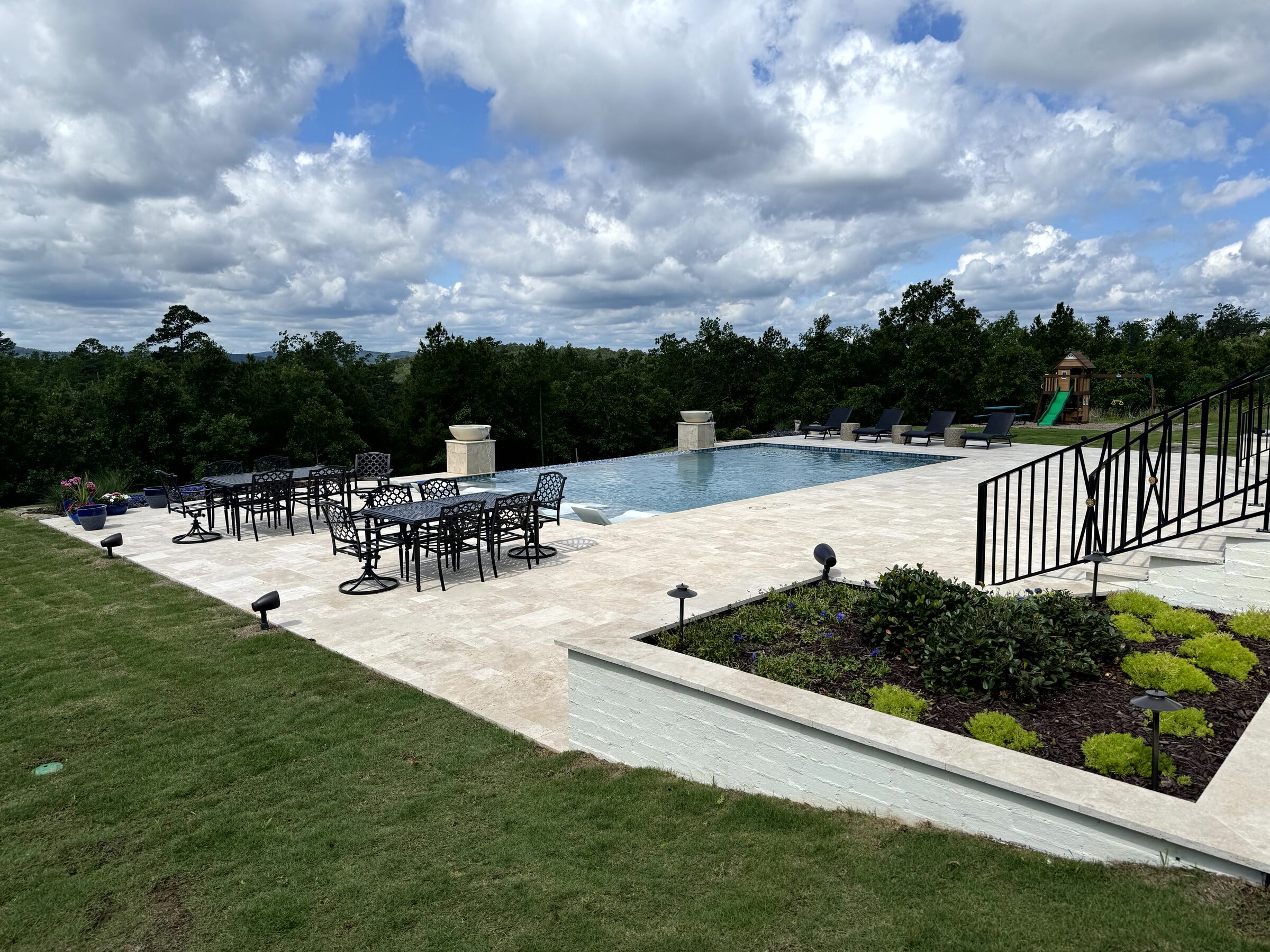 Upstairs patio with travertine-capped flower boxes overlooking the pool