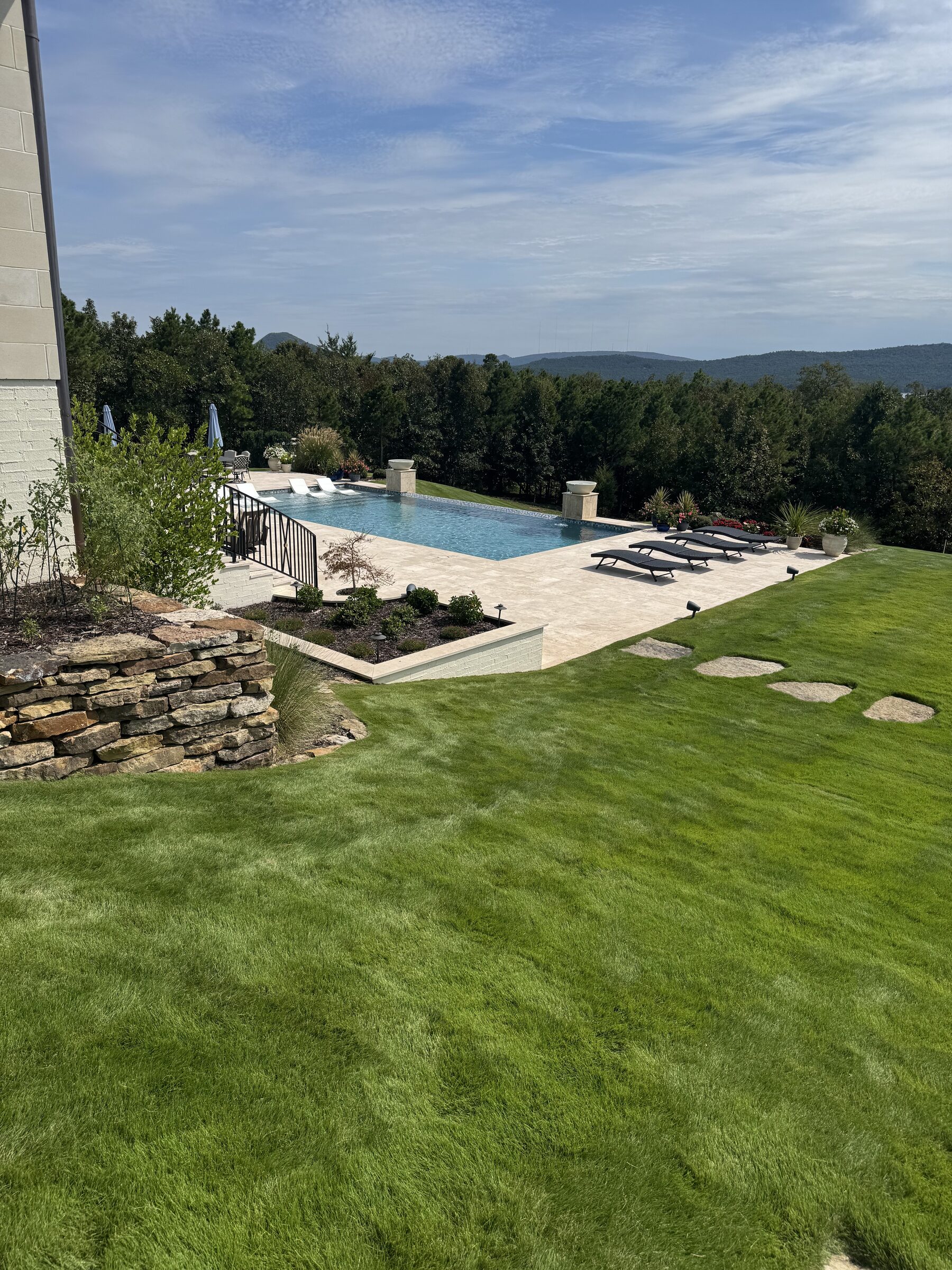 Wide angle — custom travertine deck risers on the steps