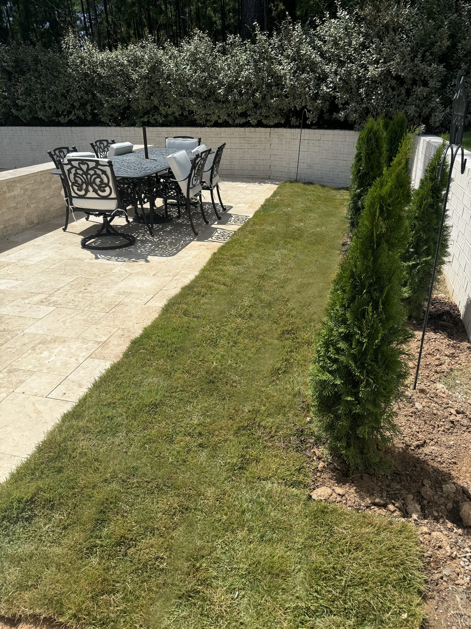 Patio overview — Versailles pattern travertine with dining and pool