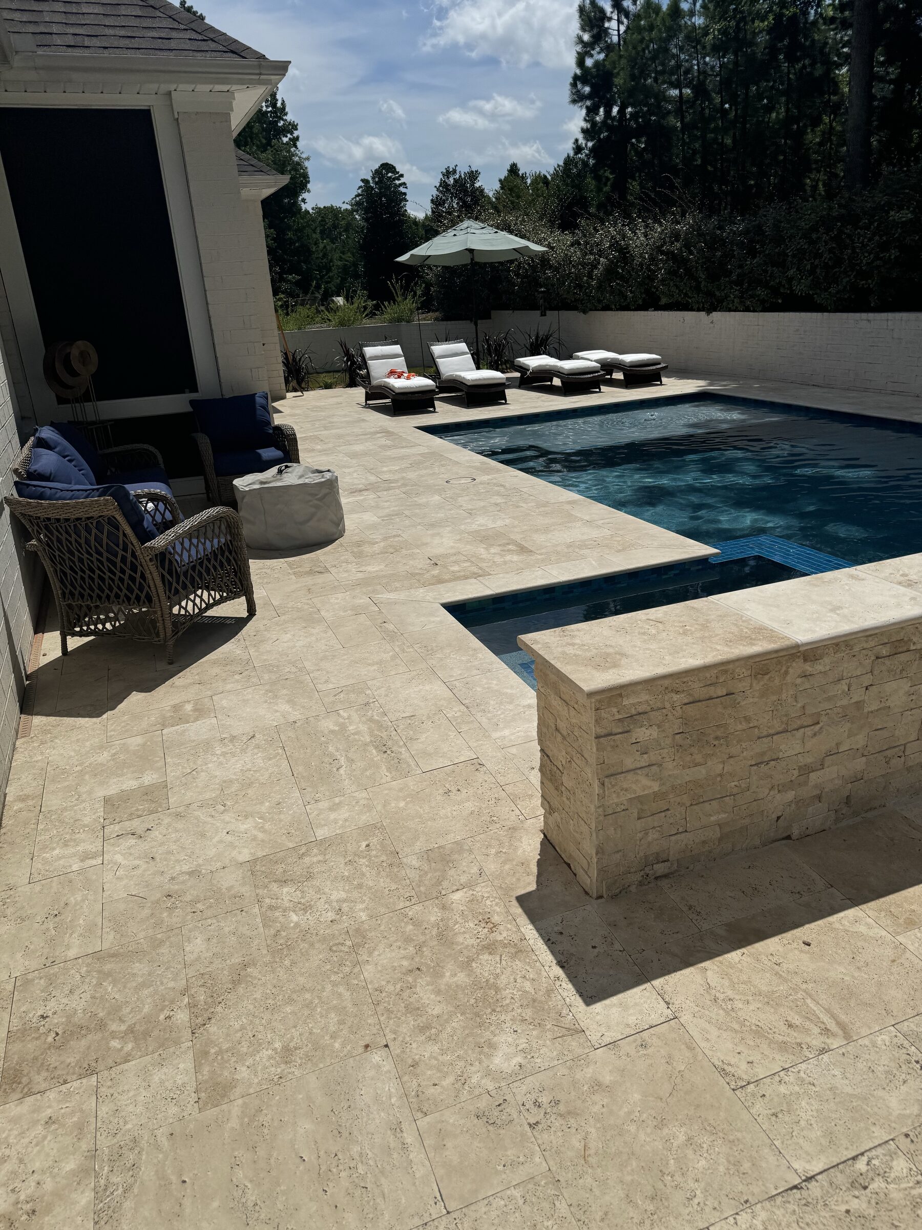 Travertine deck and raised stone wall detail