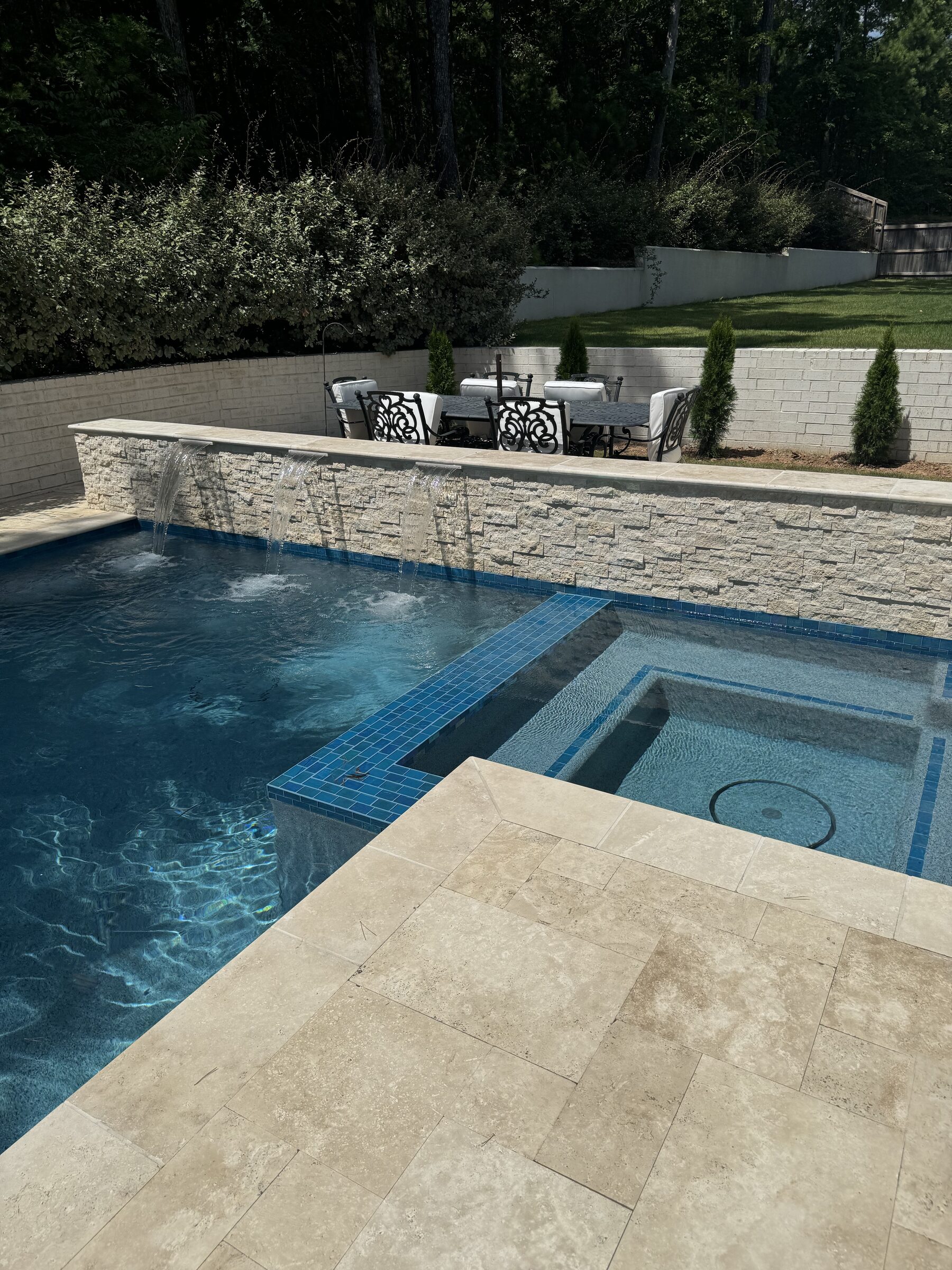 Poolside loungers on the travertine surround