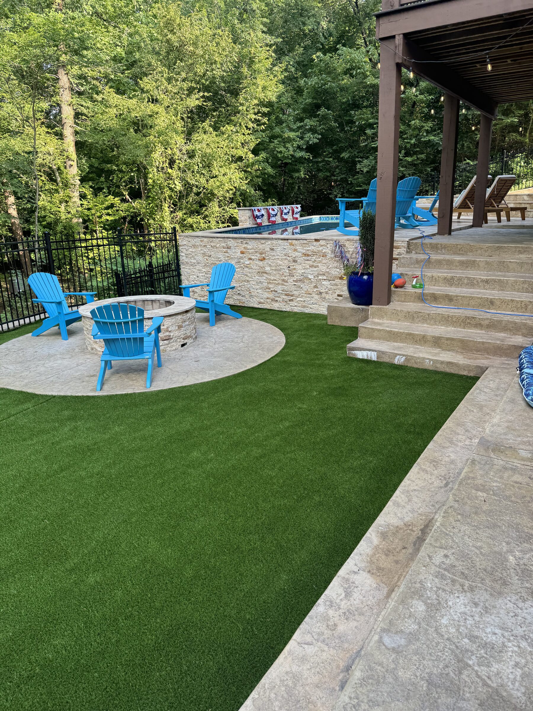 Fire pit seating area with the pool and stairs in view