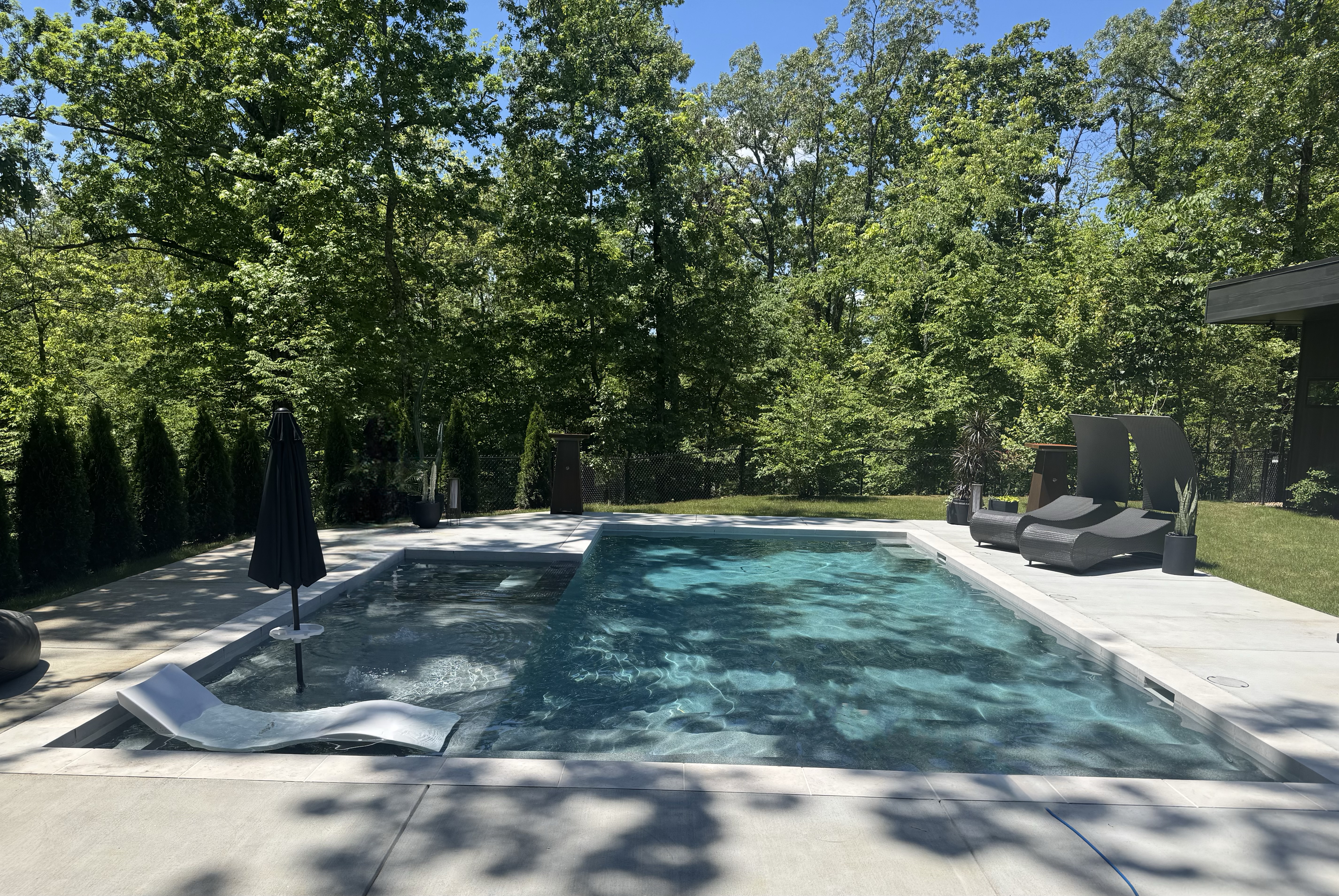 Full backyard view — pool, spa, and pool house
